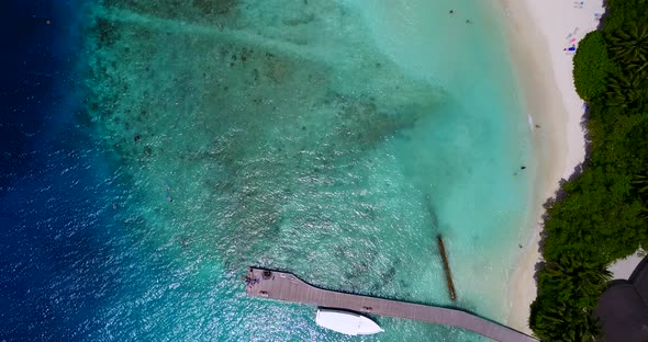 Natural above island view of a sandy white paradise beach and aqua blue ocean background in best qua