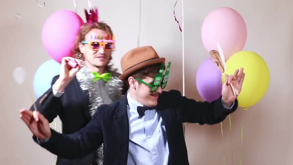 Two male friends having fun with props