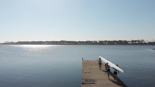 Female rowing team training on a river