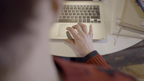 Overtheshoulder View of Caucasian Woman Using Laptop Computer