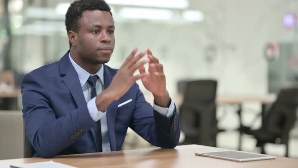 African Businessman Sitting in Modern Office and Thinking