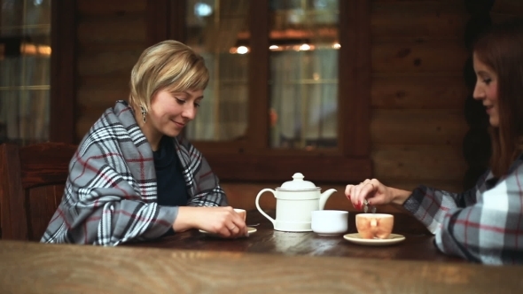 Girls Talk And Drink Their Tea From a Porcelain Teapot