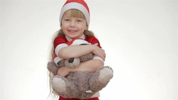 Kid Girl Hugging a Teddy Bear.
