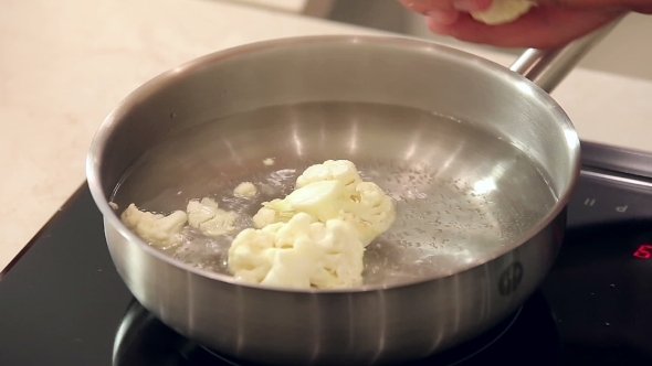 Chef Boils Chopped Cauliflower In Metal Pot