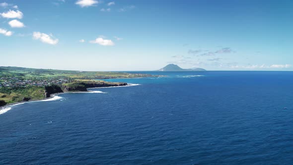 Aerial drone filming the settlemenit on the shore and mountain in Saint Kitts and Nevis