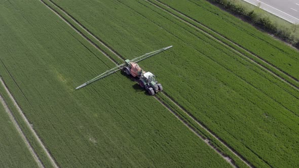 Tractor Spraying a Controversial Glyphosate Herbicide on Agricultural Land