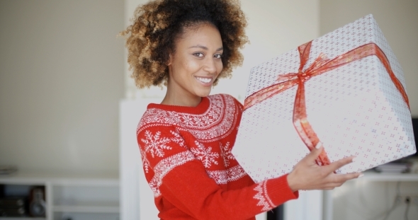 Happy Smiling Girl With Afro Haircut Holding Gift