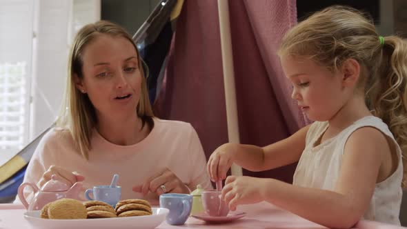 Mother and daughters playing dinette together