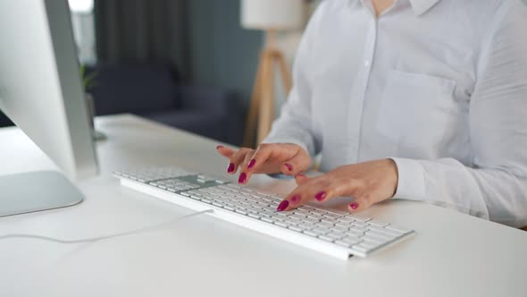 Woman Typing on a Computer Keyboard