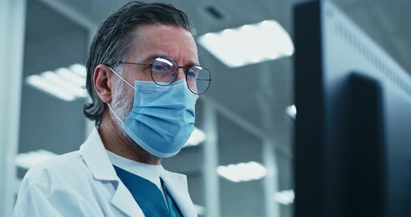 Middle Aged Doctor Using Computer in Laboratory
