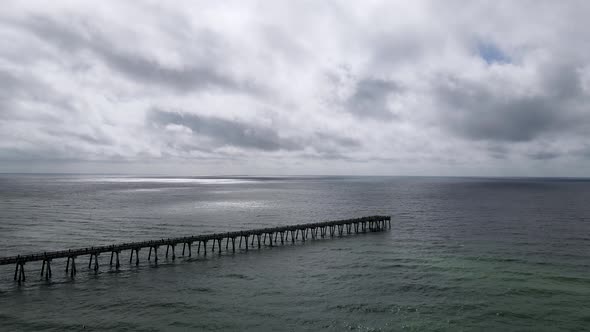 Calm Before the Storm Concept - Ocean Pier on Florida Coast Pre-Hurricane, Aerial Drone View