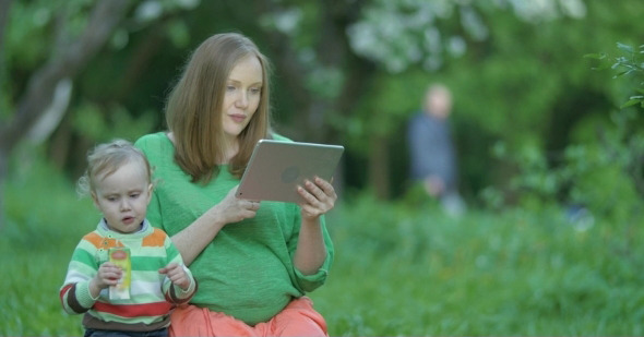 Pregnant Woman And Her Son With Tablet PC alt