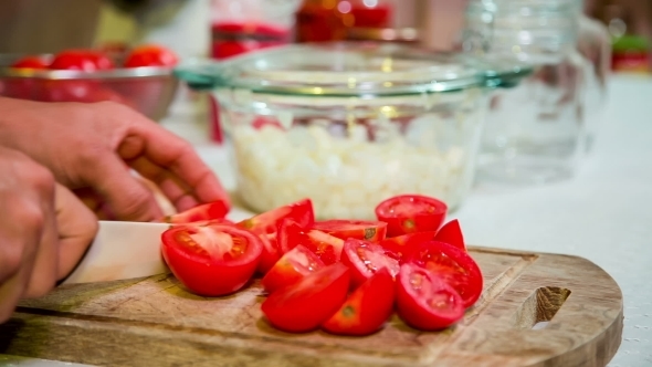 Cook Cutting Tomatoes Into Parts