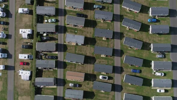 Top down aerial of a caravan holiday home park. Amazing shot of block organisation. Mobile towed car
