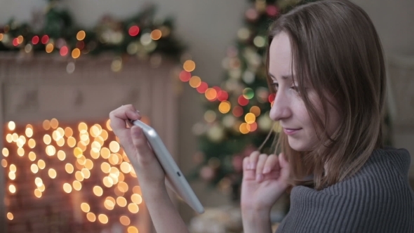 Happy Woman Looking In Tablet PC In Front Of