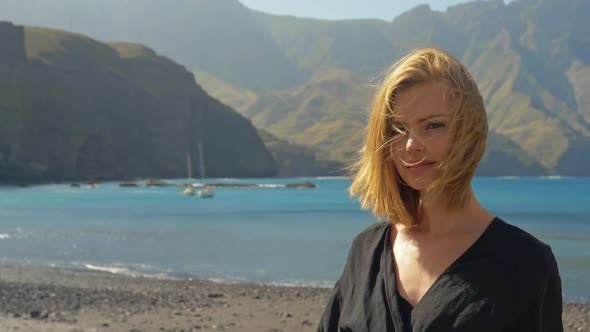 Slow Motion Shot of a Blonde Model Feeling the Wind then Stares at the Camera