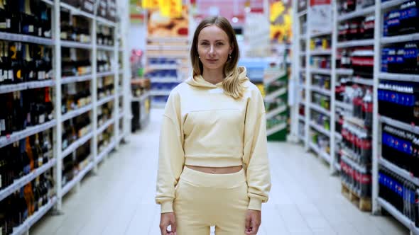 Woman Stand in Between Shelfs in Store