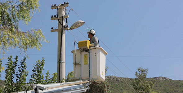 Boom is Lifting Worker to Street Light