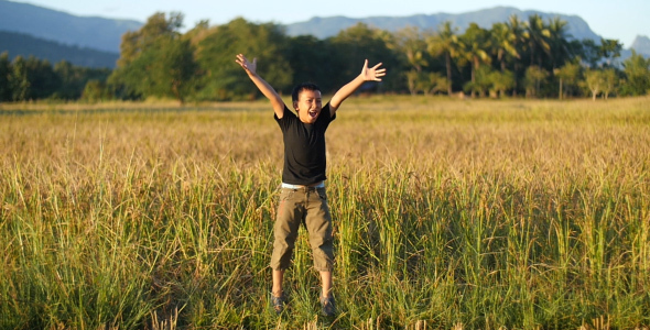 Young Boy Happy Jump In Rice Field