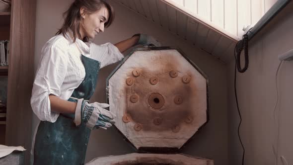 Potter Preparing the Pottery Kiln for the Baking Process for Her Dish