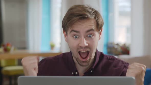 Happy Hipster Man Freelancer Cheering Success While Work at Home with Laptop