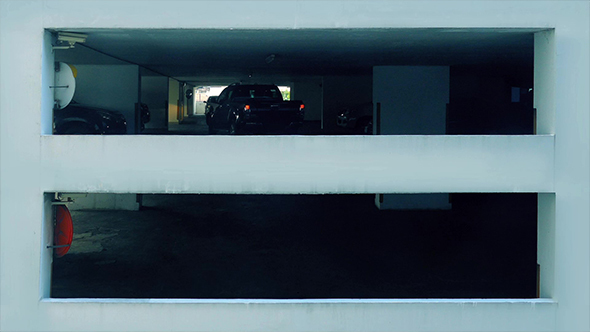 Car Drives Around In Multi-Level Parking Garage