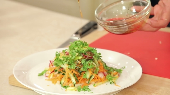 Chef Is Pouring Dressing Into Freshly Cut