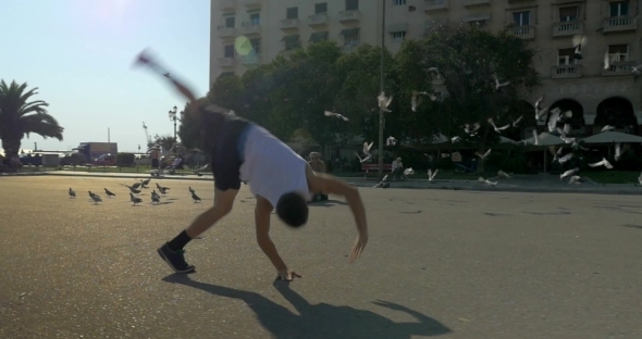 Teenager Doing Acrobatics On City Square