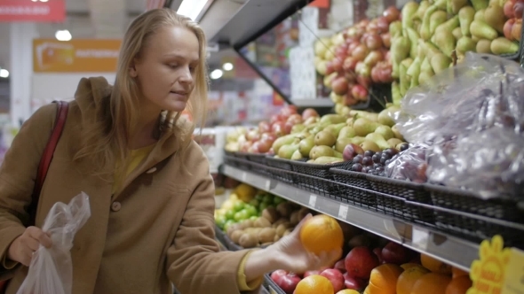 Young Woman Choosing Fresh Fruit