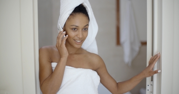 Attractive Young Woman Using Phone In Bathroom