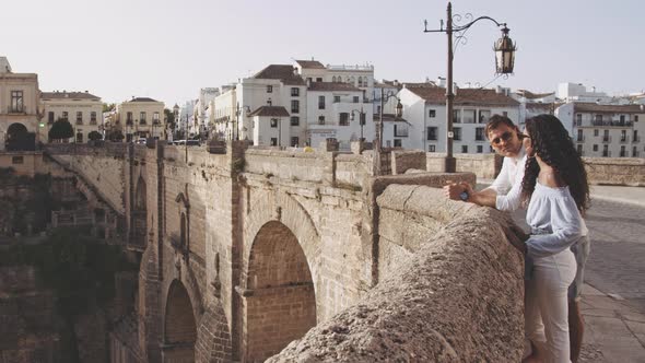 Young Couple At Wall In Ronda