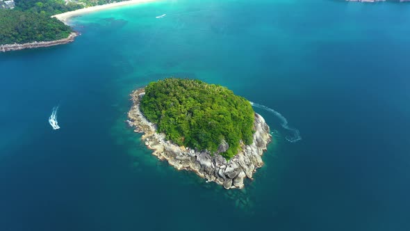 Nice rocks forested island, aerial panorama of Ko Pu against mountainous Phuket landscape on backgro