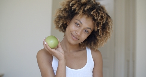 Young Woman With Green Apple In Hands