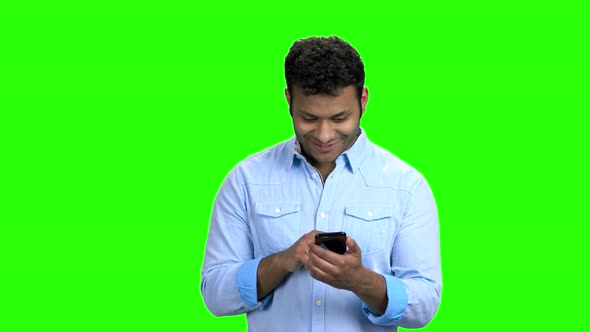 Handsome Indian Man Using Phone on Green Screen