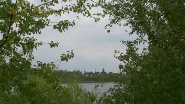 Tube of Factory Distantly on The Opoosite Bank of