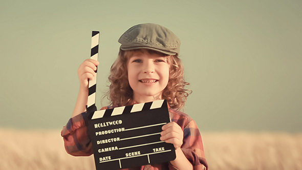 Kid Holding Clapper Board In Hands