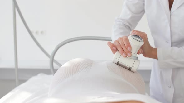 Young Female Therapist Doing Beauty Therapy with LPG Machine in Medical Clinic.