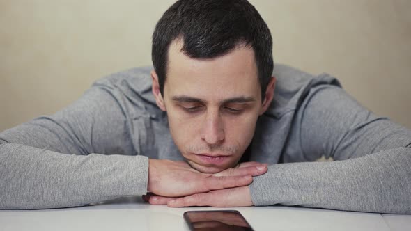 Man Waiting Phone Call Lying on a Table