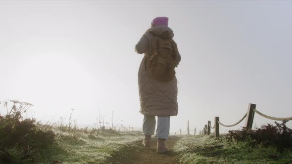 Slow Motion Traveler Woman in Coat with Backpack Enjoying Sunny Early Morning 6K