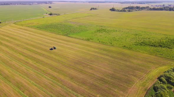 Panorama Agricultural Machinery is Harvesting in the Field Aerial View