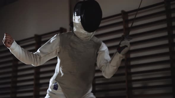 Man In Fencing Mask Duelling Opponent