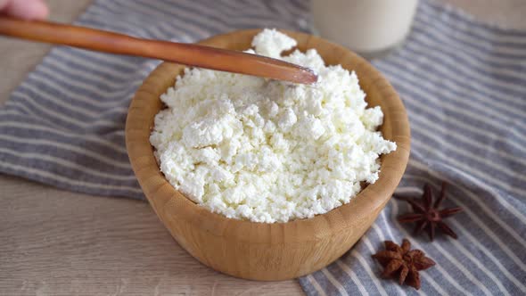 Traditional homemade cottage cheese in a wooden bowl Healthy and fermented food