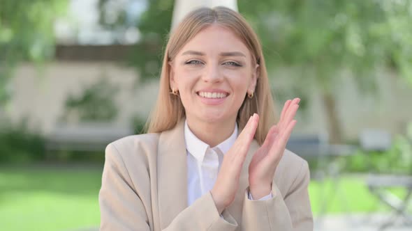 Outdoor Portrait of Young Businesswoman Clapping Applauding