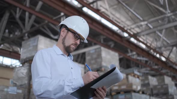 Employee Male Warehouse Worker Engineer Man in Hard Hat Working at Construction Site Warehouse