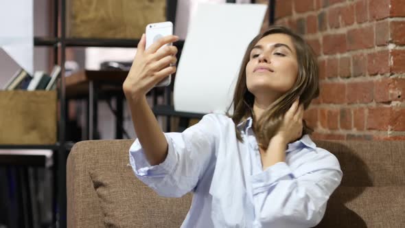 Sitting Beautiful Lovely Girl Taking Selfie with Smartphone