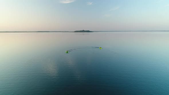 Two Canoes with Four Rowers Sail on Lake Svityaz Ukraine