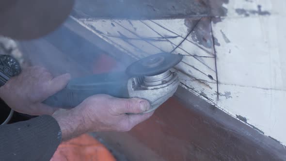 Cutting out rotten mahogany planks with angle grinder on wooden boat. MEDIUM CLOSE UP, SLOW MOTION