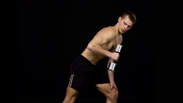 Man Works on His Figure. Weights for Fitness