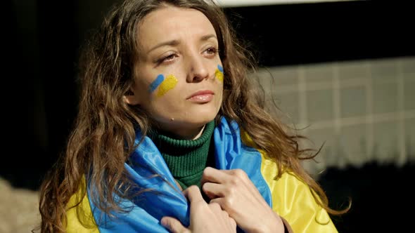 Portrait of a Woman with a Ukrainian Flag on His Shoulders