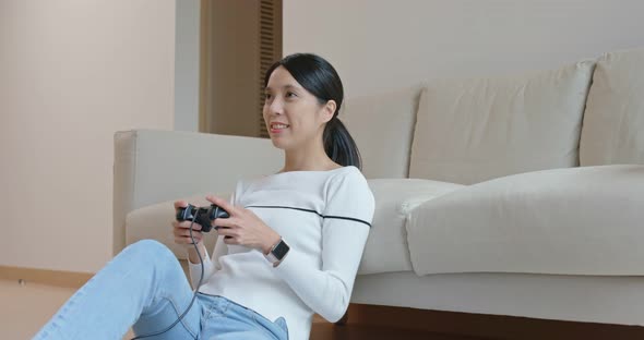 Woman play tv game at home